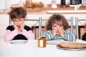 Kids pouting in the kitchen